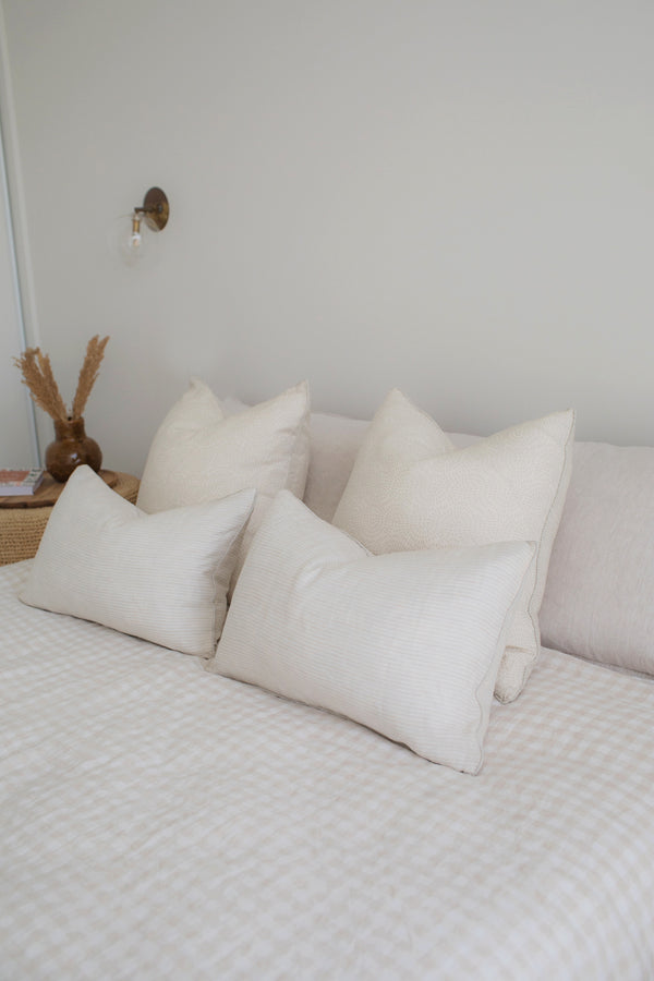 French linen cushion on bed